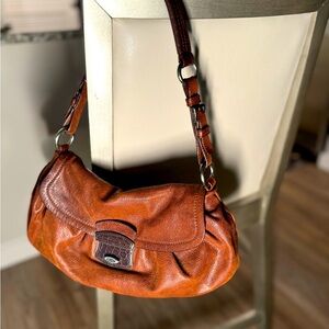 PRADA purse: rich brown leather bag with pretty pink lining. Adjustable strap.